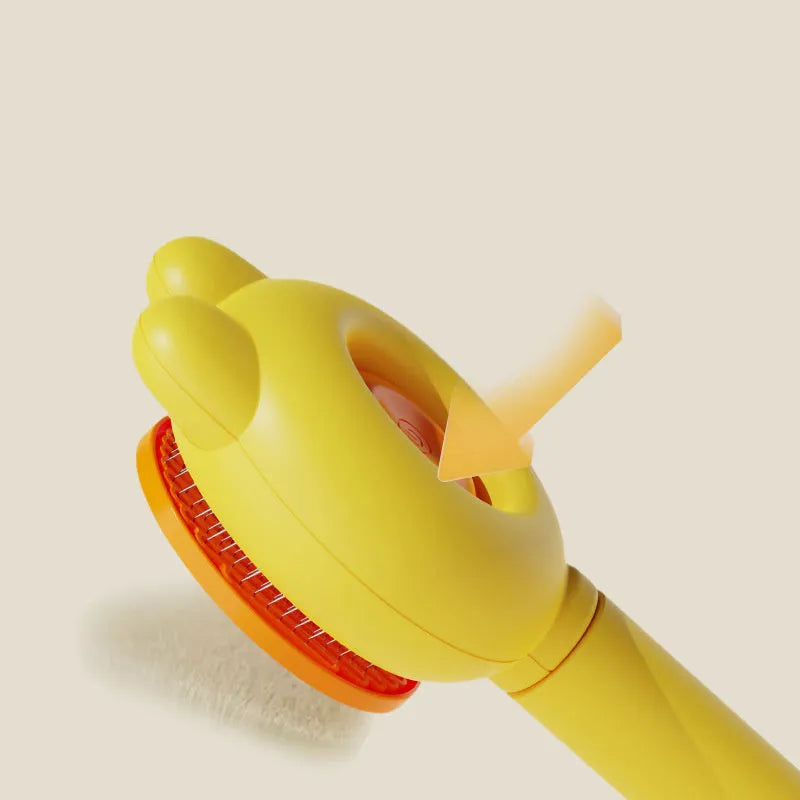 Green pet grooming brush with a self-cleaning button and a stainless steel comb.