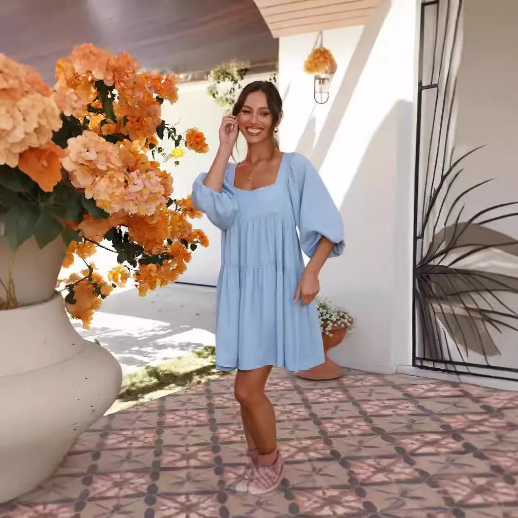 Girl in a light blue square collar puff sleeve backless A-line summer dress.