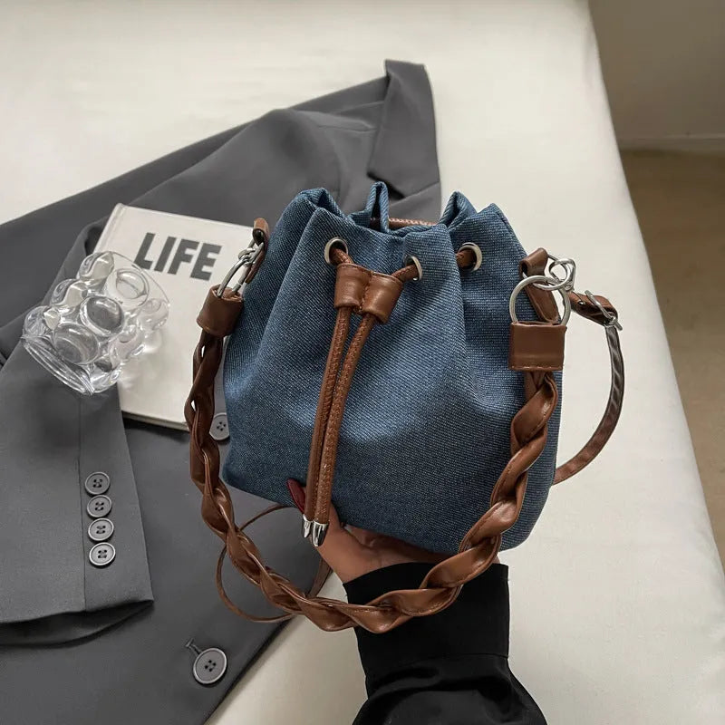 Blue synthetic leather cross body bucket bag with sandwich pocket construction