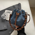 Blue synthetic leather cross body bucket bag with sandwich pocket construction