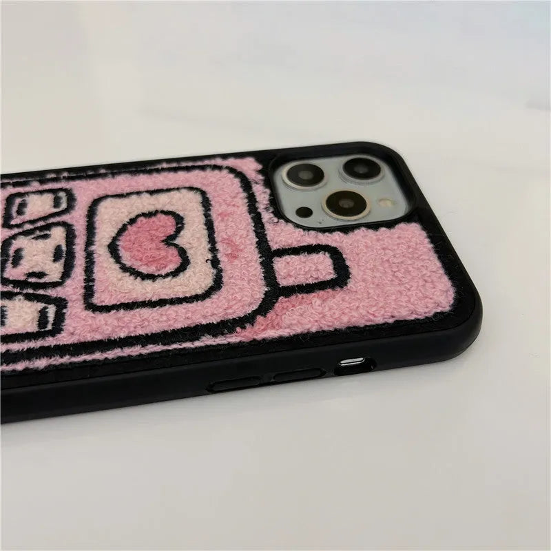 Pink TPU iPhone case with embroidered towel pattern design on the back.