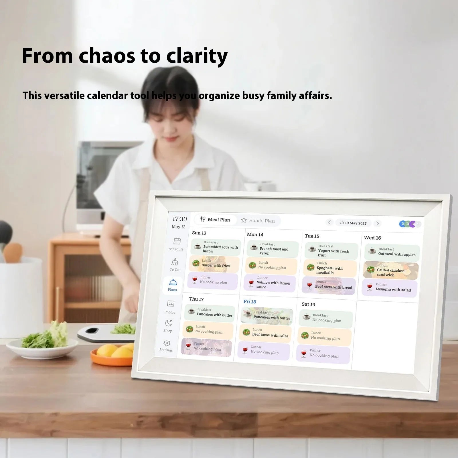 White 15.6-inch digital photo frame displaying family photos with smartphone app control interface