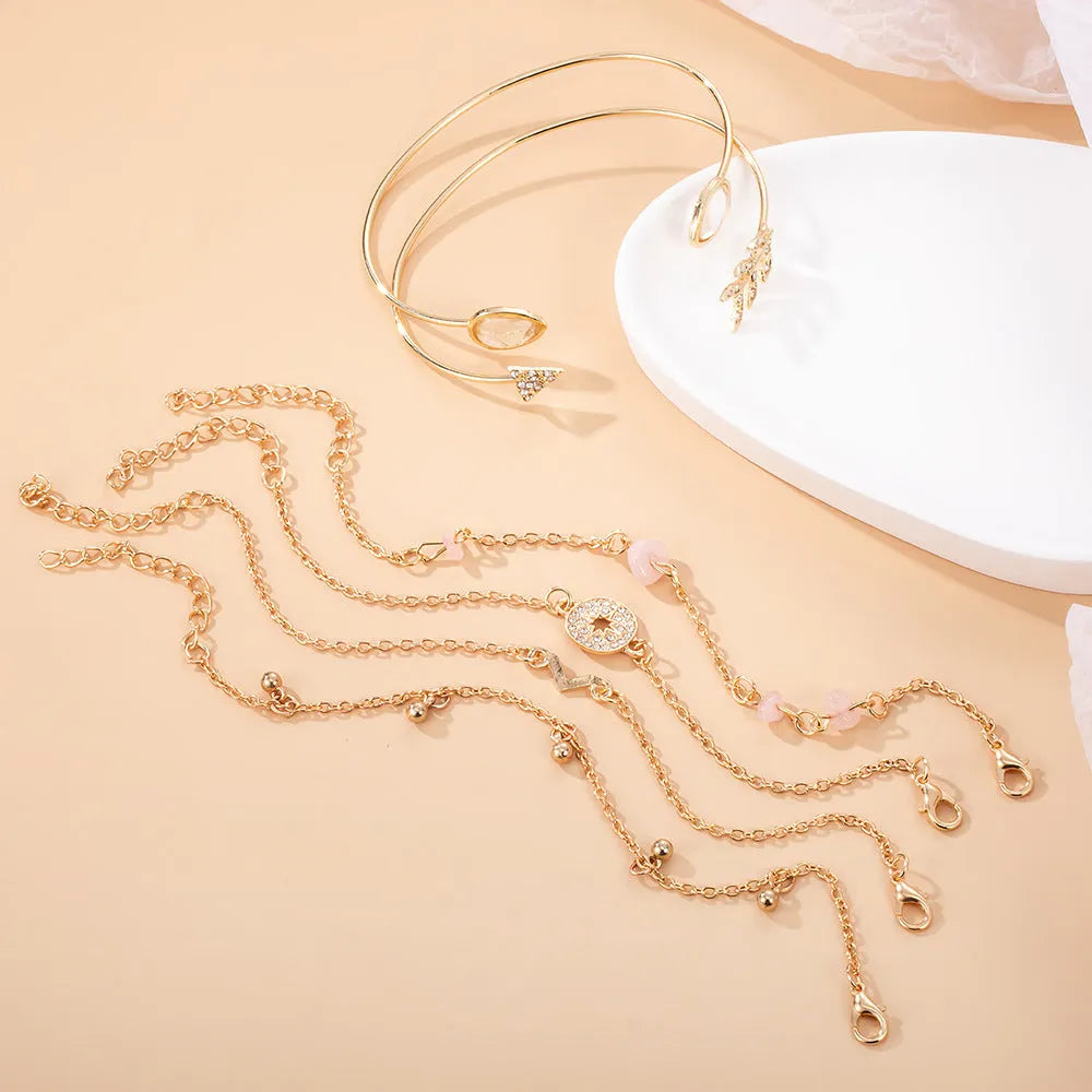 Gold-coloured six-piece zinc alloy bracelet set with water drop, V-shaped, arrow, drill and spot designs