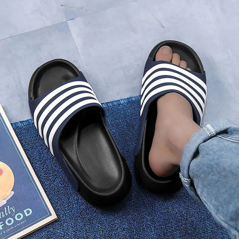 A pair of beige unisex casual sliders with a PVC upper and textured EVA sole.