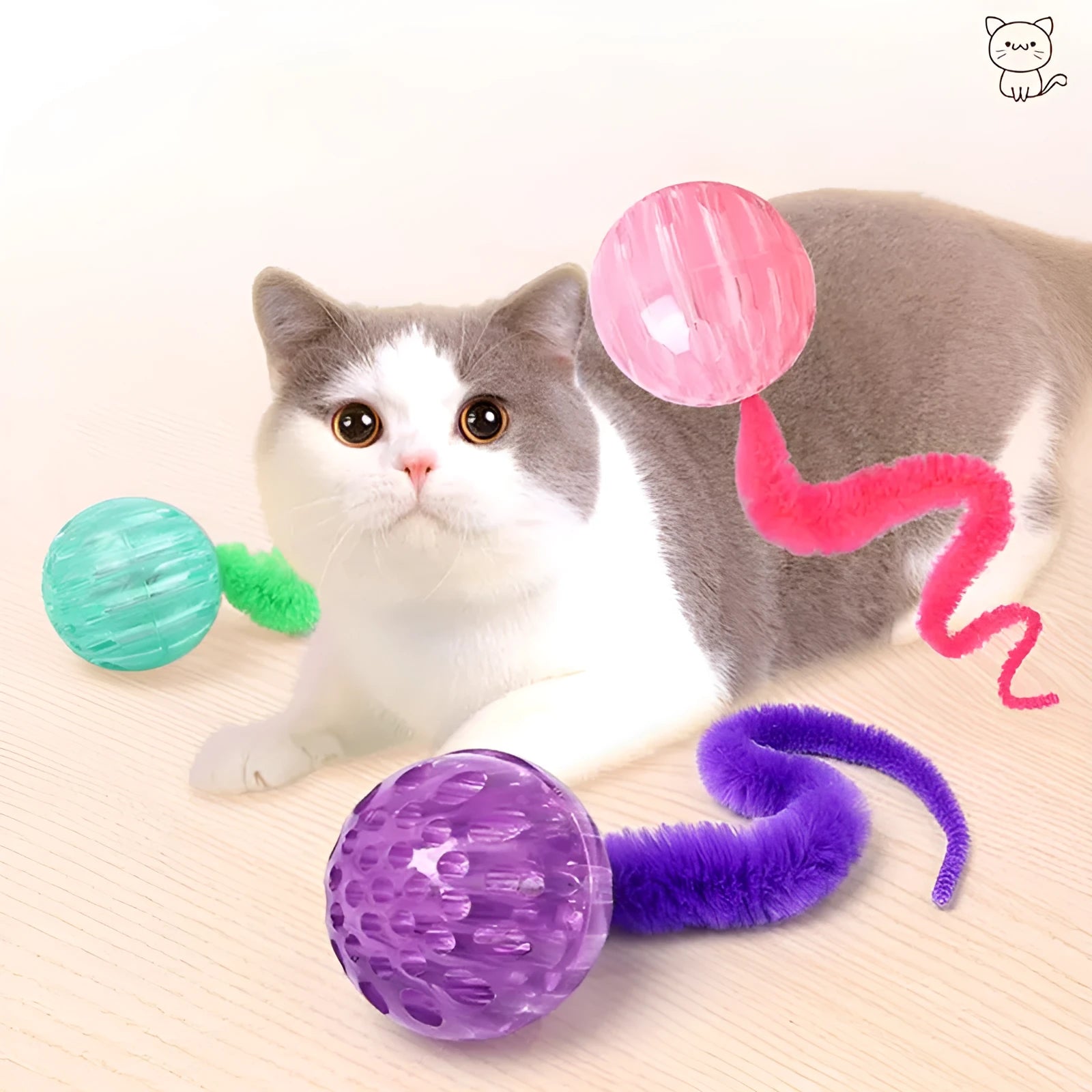 Green bouncy ball cat toy with plush tail on wooden floor