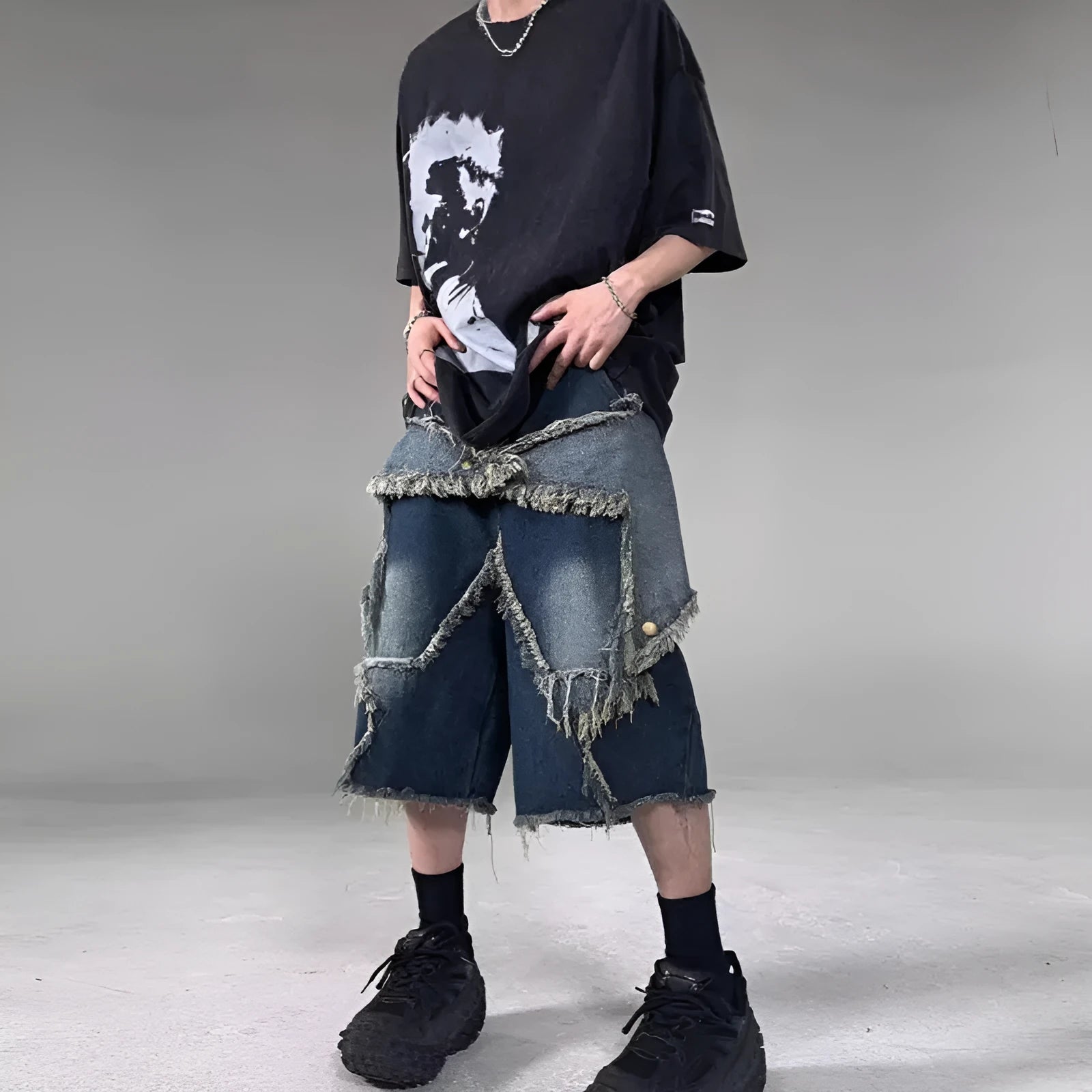 Blue denim shorts with frayed hems and star patches in loose fit American retro style