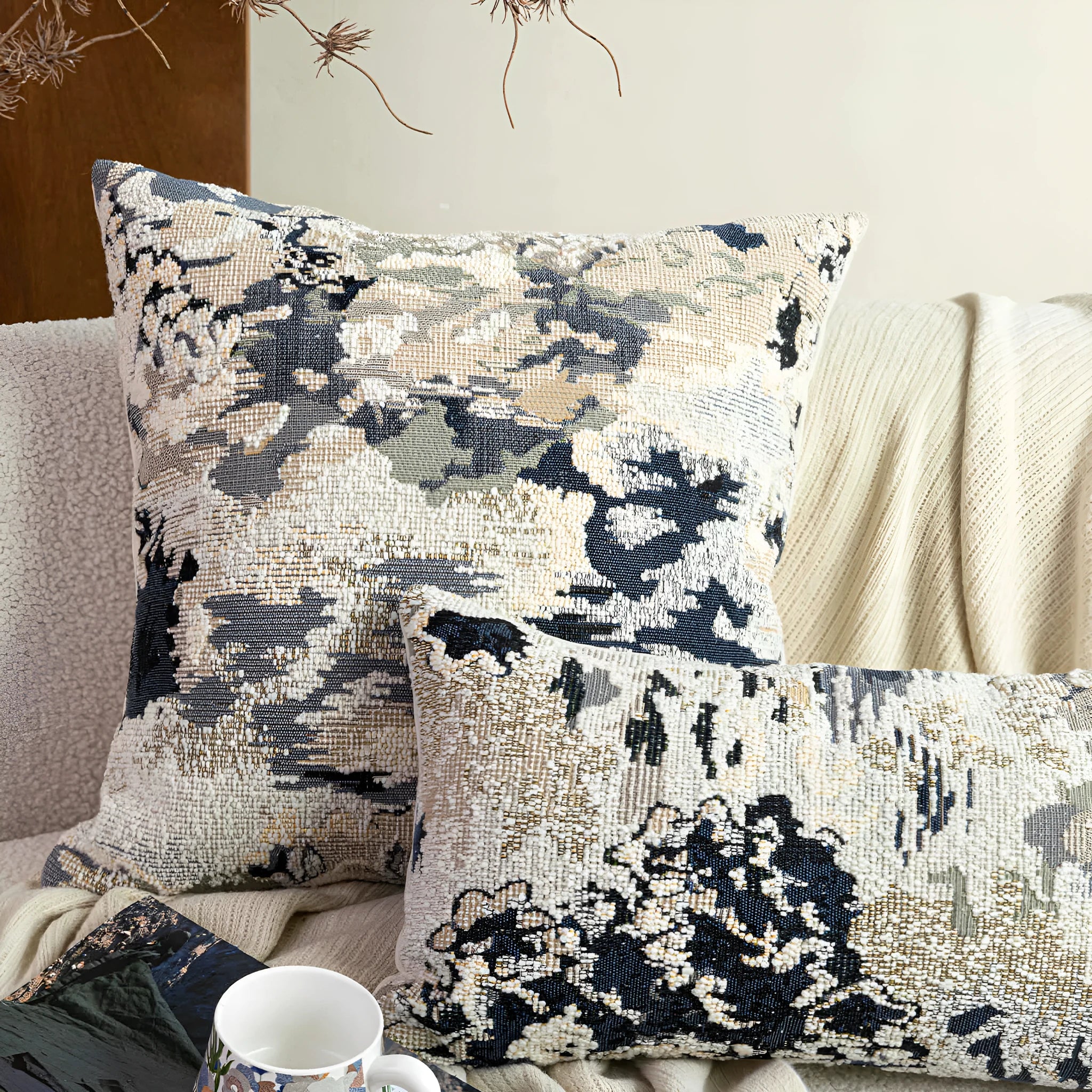 Antique blue cushion with embroidered floral pattern in Chinese style on a sofa