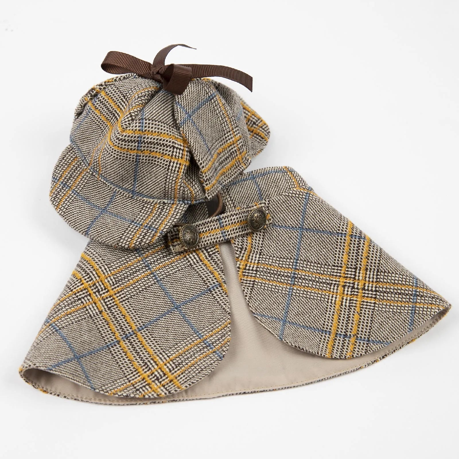 Camel coloured cotton detective cloak for dogs on a hanger, showing the adjustable hat.