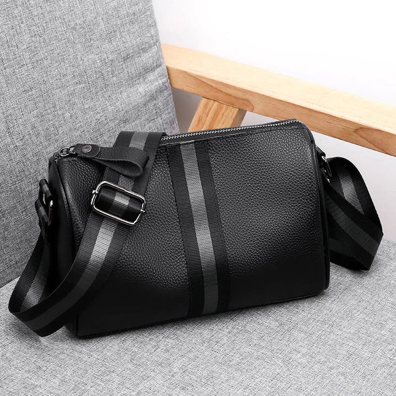 Black genuine leather crossbody bag with polyester lining measuring 24x16x13cm