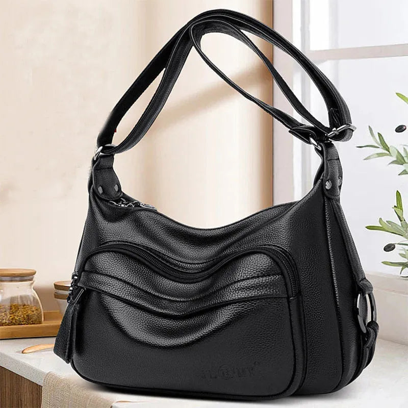 Large blue soft PU women's shoulder bag with a zipper and organised interior compartments.