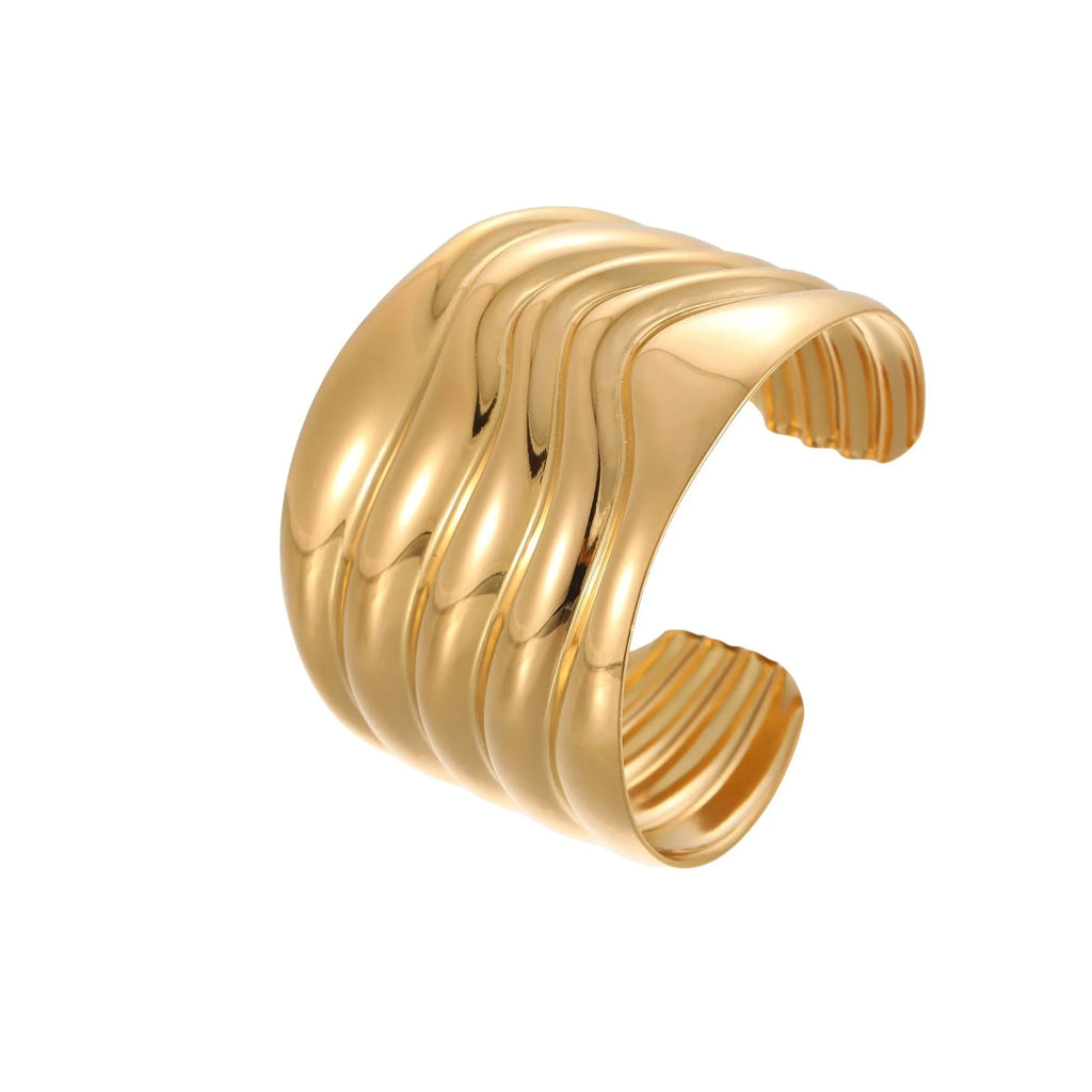 Women's fashion bracelet with exaggerated width, geometric wave patterns, and gold plating