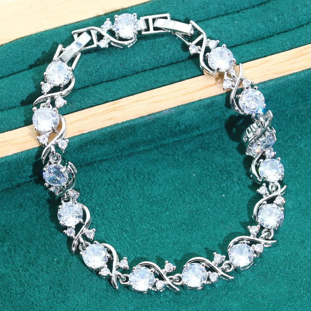 Bridal zircon jewellery four-piece set showing necklace, bracelet, earrings, and ring with water wave chain styling