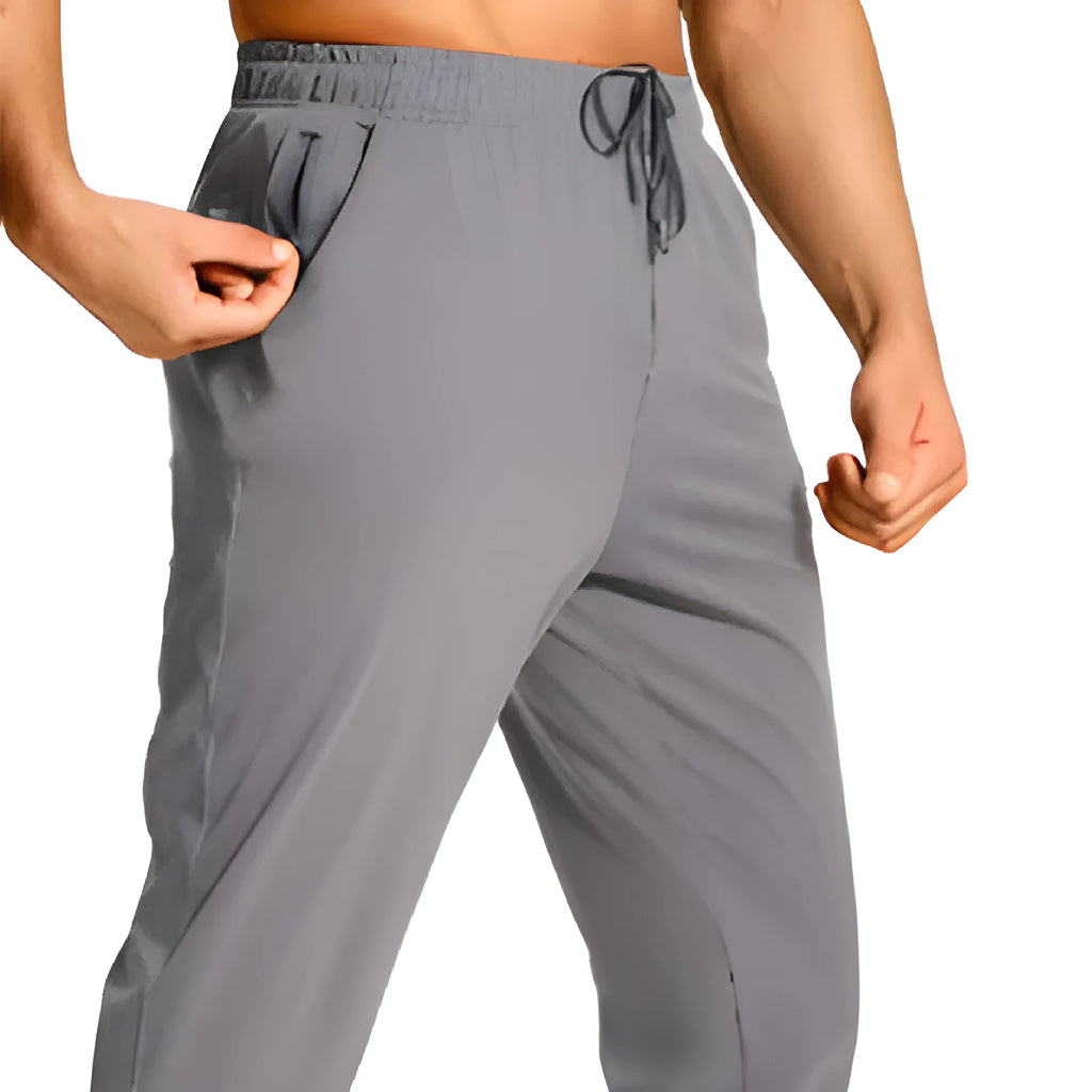 Men's loose fit solid colour casual trousers in polyester fabric on a hanger