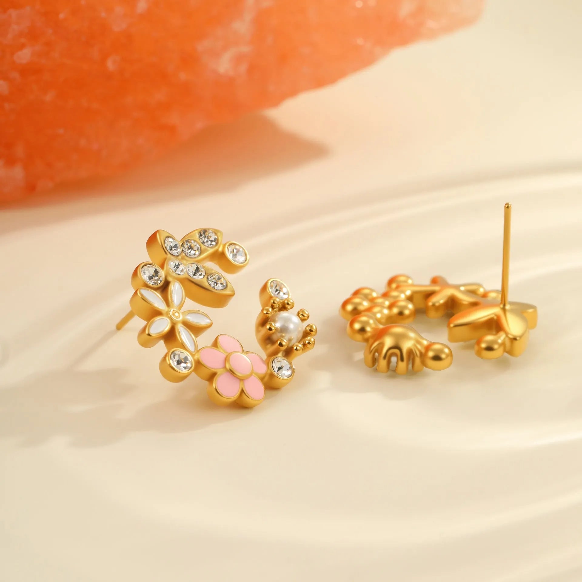 A pair of flower-shaped petal stud earrings with colourful oil finish and 18K electroplating on stainless steel.