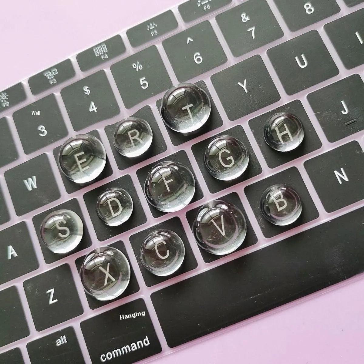 Crystal glass ball keyboard stickers in 12x6mm size on a white keyboard showing raised design