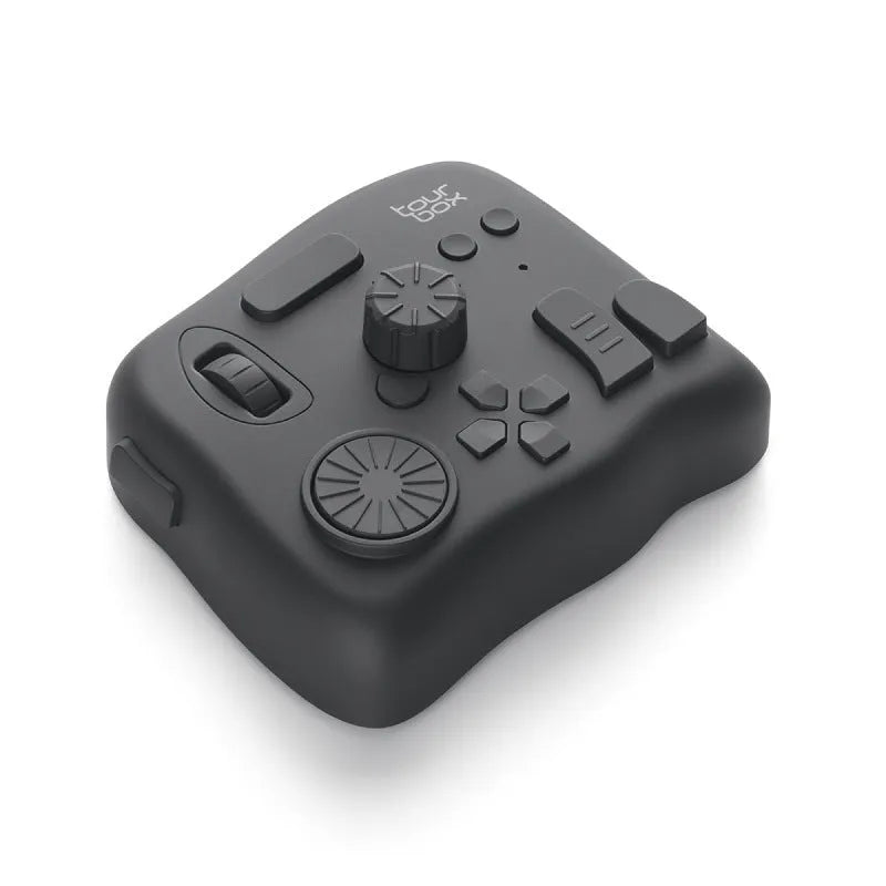 TourBox NEO black USB video editing controller auxiliary keyboard on a desk.