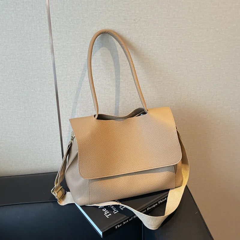 A brown PU tote bag with double shoulder straps and visible sewing thread detail.