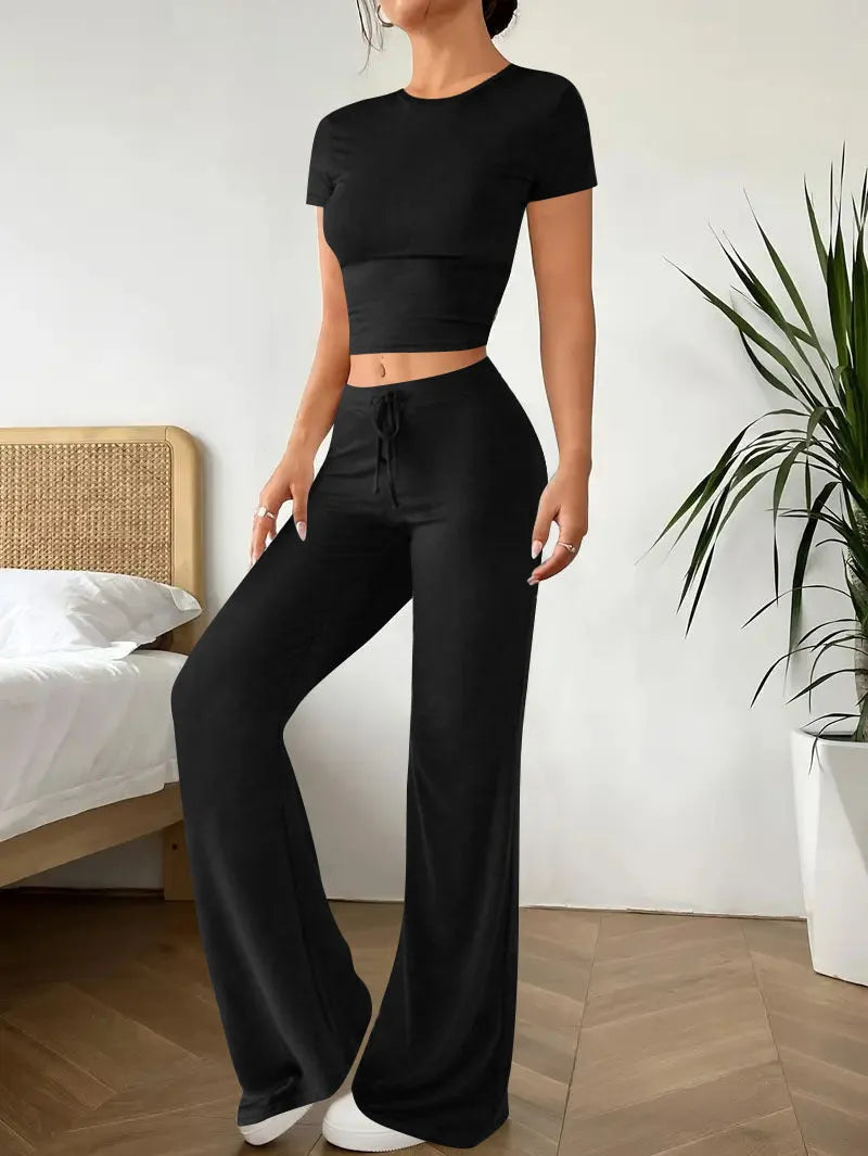 Women's black polyester trouser and T-shirt co-ord set showing complete outfit