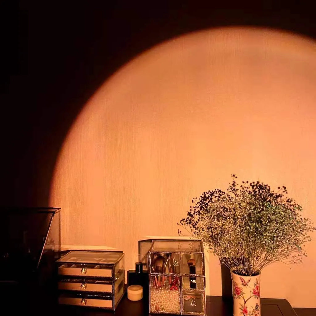 Rechargeable sunset projection lamp showing rainbow colour patterns with USB power cable