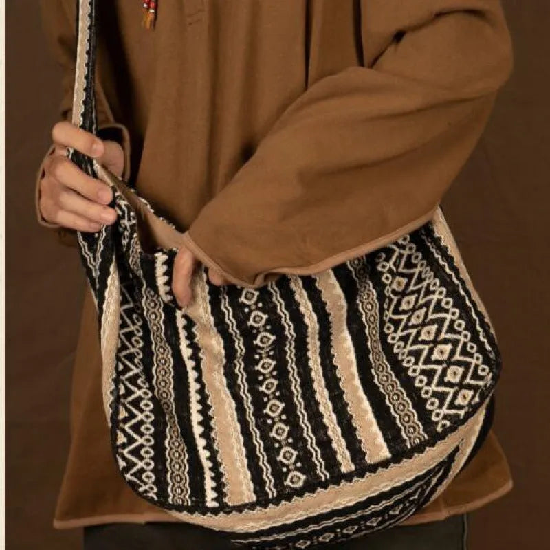 Retro striped corduroy messenger bag with jacquard detail and an adjustable plaid shoulder strap.