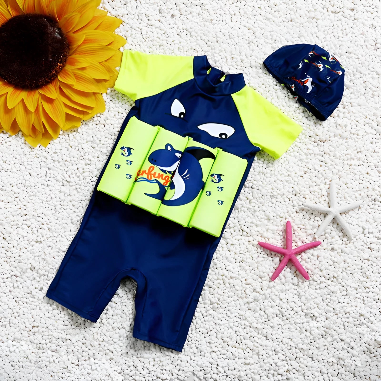 Child wearing a unisex buoyancy swimsuit with a cartoon shark design in a swimming pool.