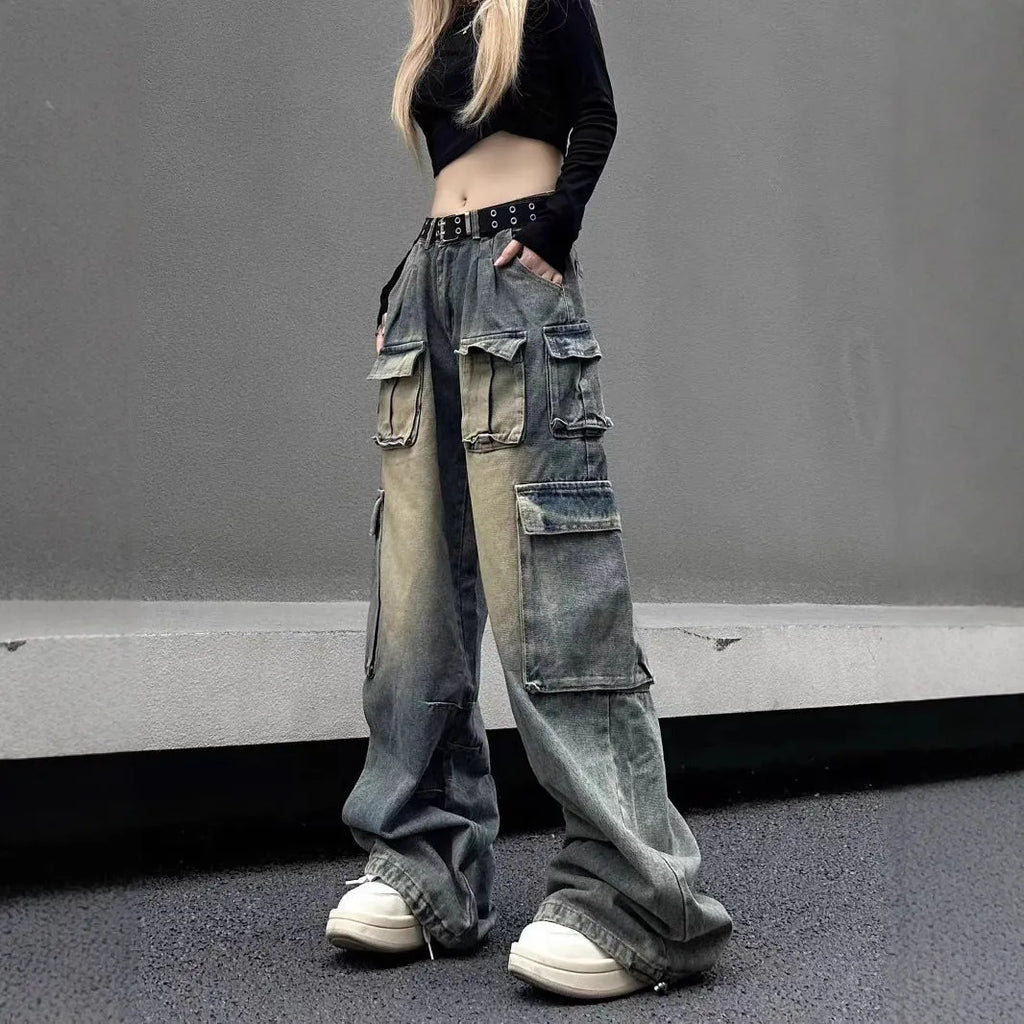Loose-fit light blue distressed denim jeans with multiple tooling pockets on a straight-leg cut