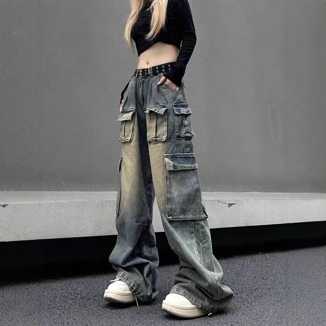 Loose-fit light blue distressed denim jeans with multiple tooling pockets on a straight-leg cut
