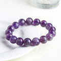 Natural feather amethyst bracelet with purple scattered beads and Ruyi design element.