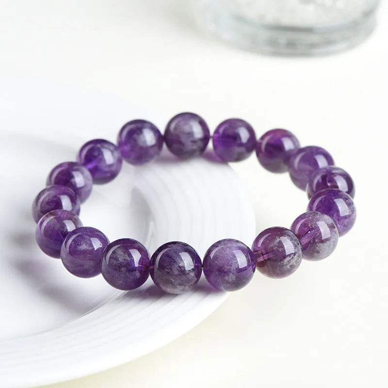 Natural feather amethyst bracelet with purple scattered beads and Ruyi design element.