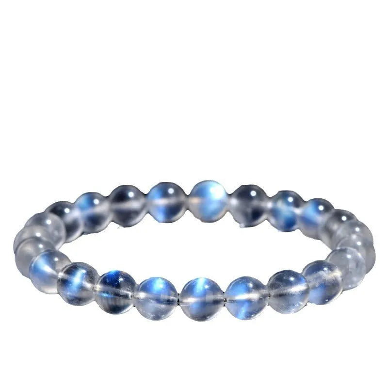 Natural cream coloured crystal bracelet with smooth ground beads, shown in a minimalist unisex style.