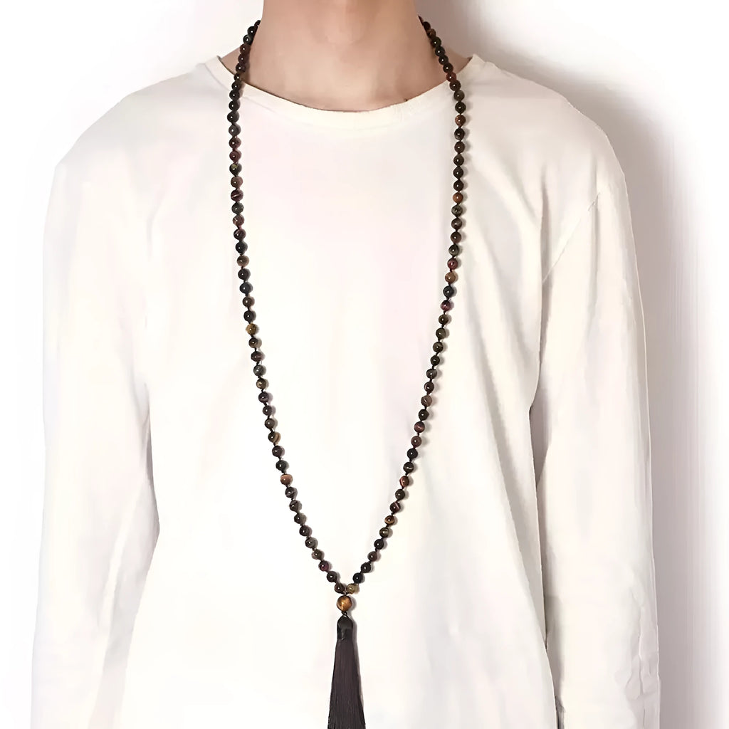 Long agate and amethyst gemstone tassel necklace with geometric pendant on a model.