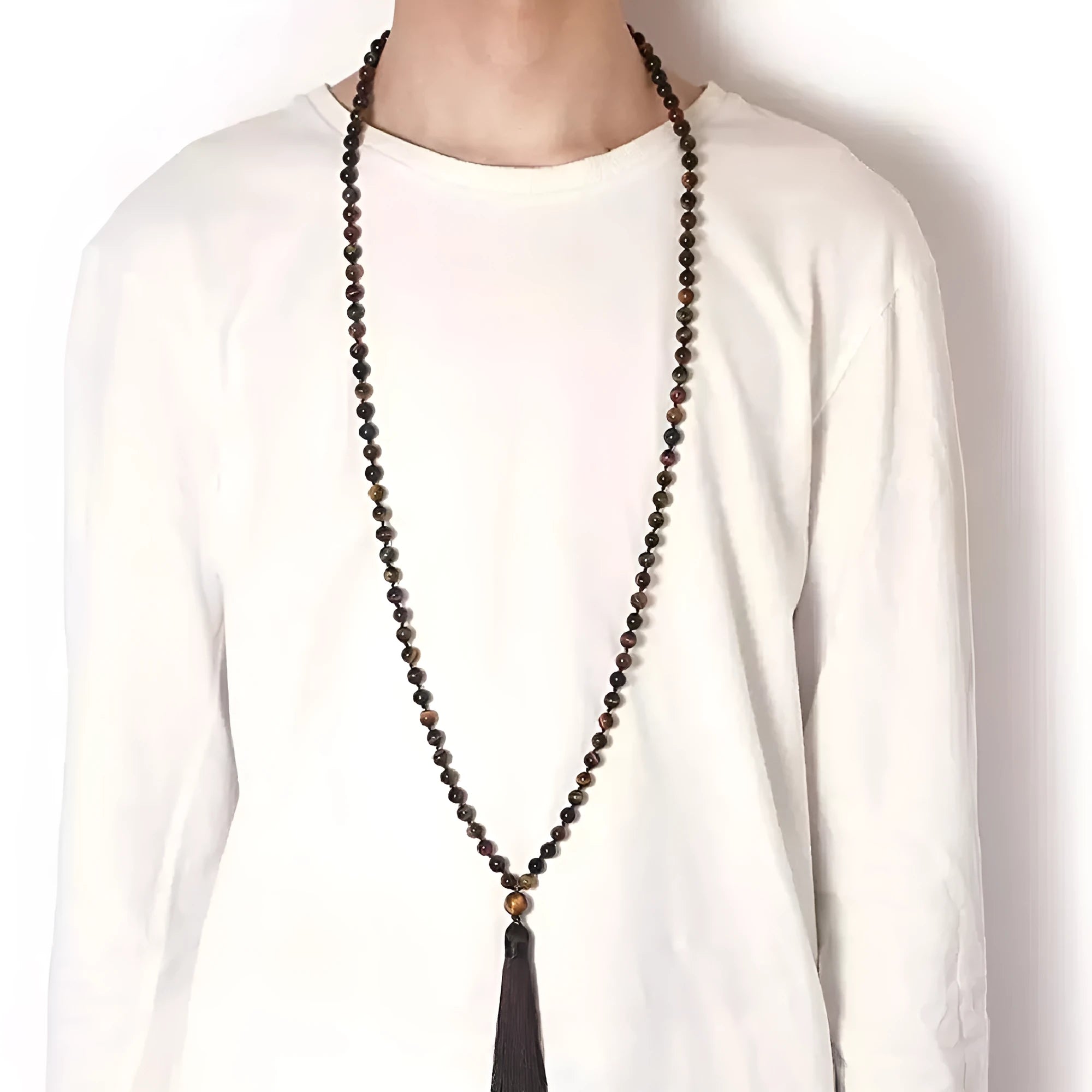 Long agate and amethyst gemstone tassel necklace with geometric pendant on a model.