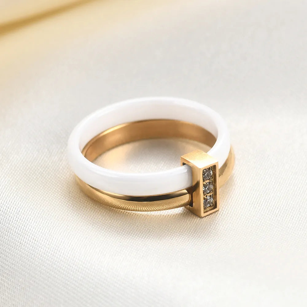 Women's glossy ceramic ring with geometric zirconium inlay in golden white or steel black colour