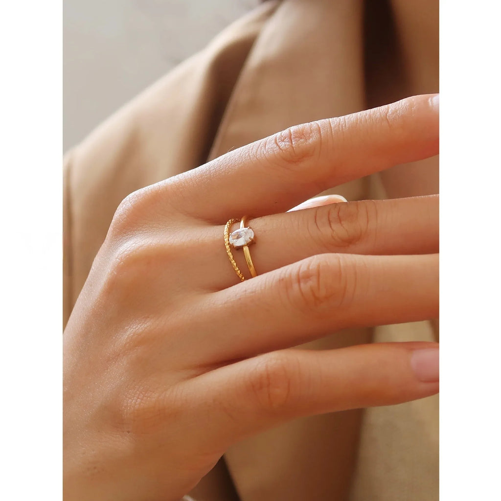 Golden heart-shaped stainless steel ring with electroplated finish shown in sizes 6, 7, and 8