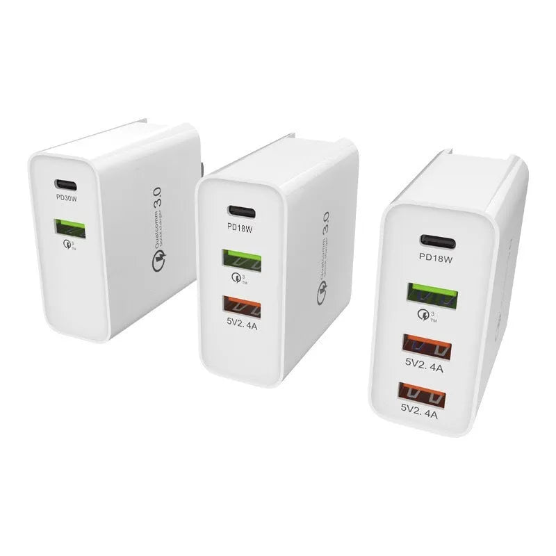 White multi-port USB fast wall charger with PD and QC support showing several device cables plugged in.