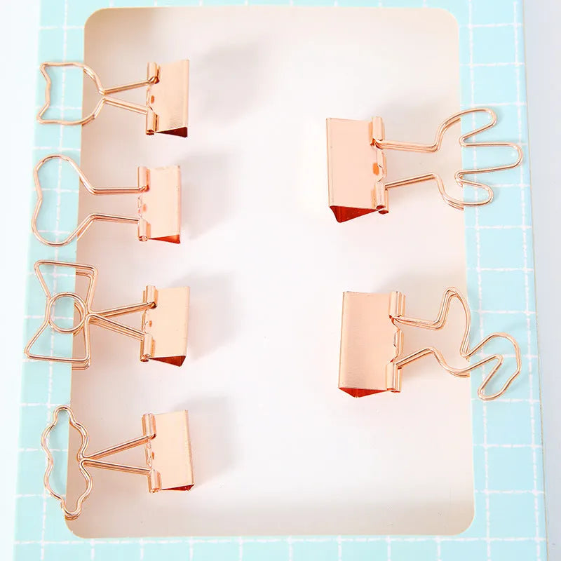 Gold metal paper clip with decorative shape options including bow, cactus, cat, flamingo, love, and clouds.
