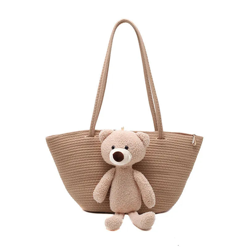 Woven cotton linen shoulder bag in dumpling shape with double straps and three-dimensional pocket.
