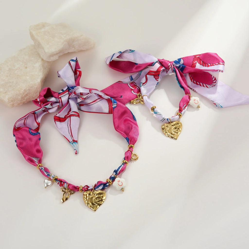 Gold-plated stainless steel necklace and bracelet set with geometric love pendant on adjustable chain