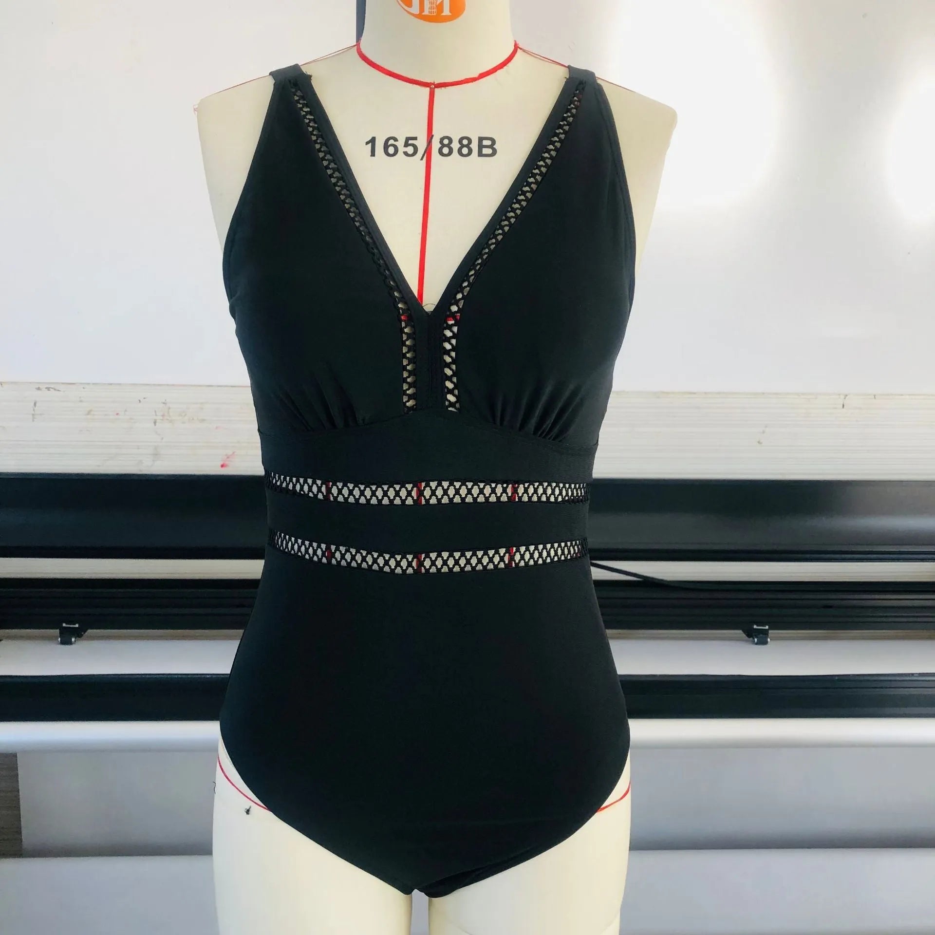 Black printed plus-size bikini swimsuit for women on a hanger.