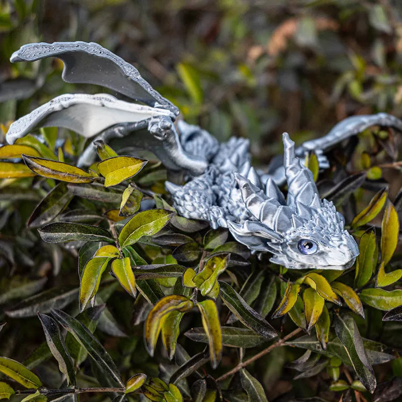 3D printed red and gold flying dragon wings decoration toy on a white background.