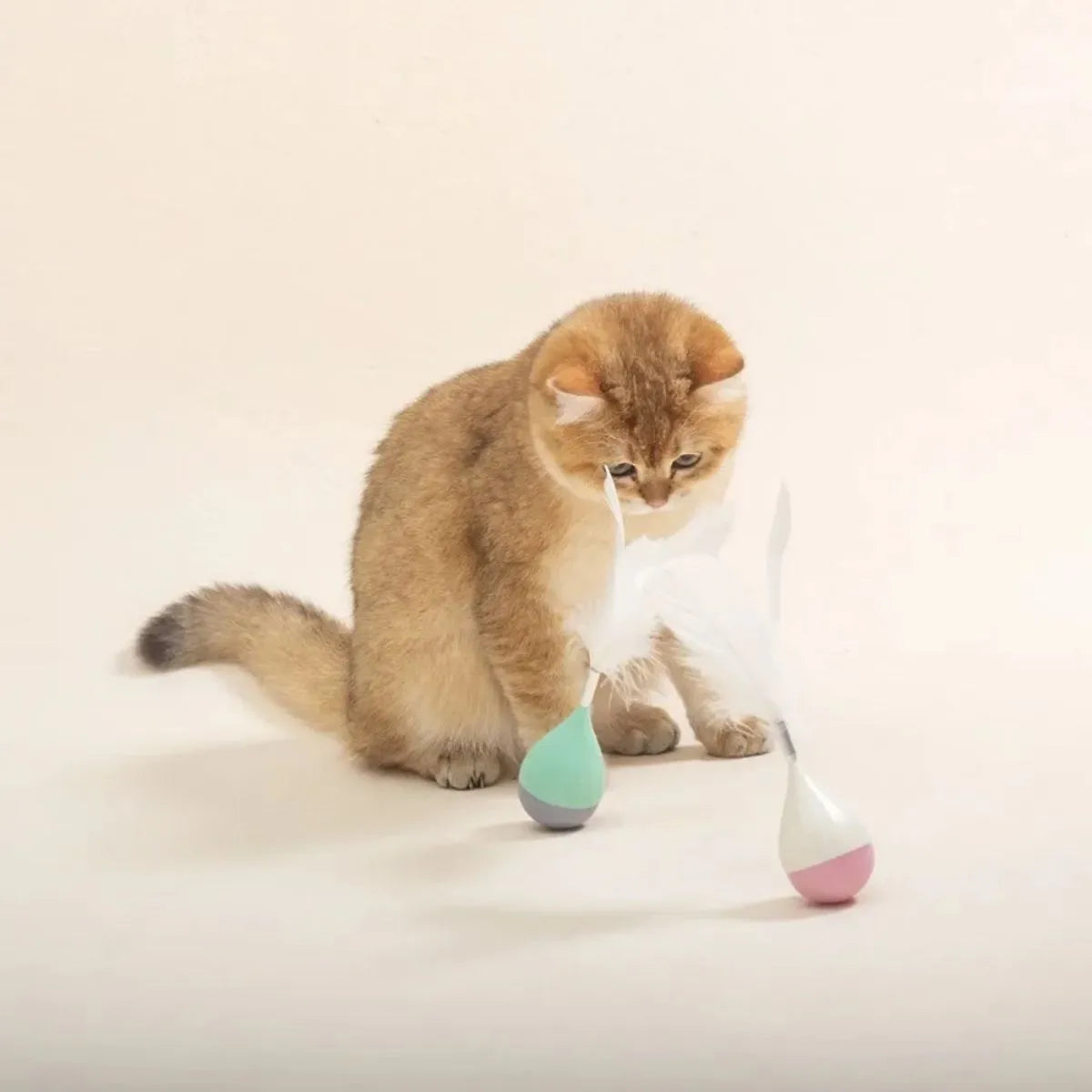 Green or pink feather tumbler cat toy with aluminium rod and self-healing ball component