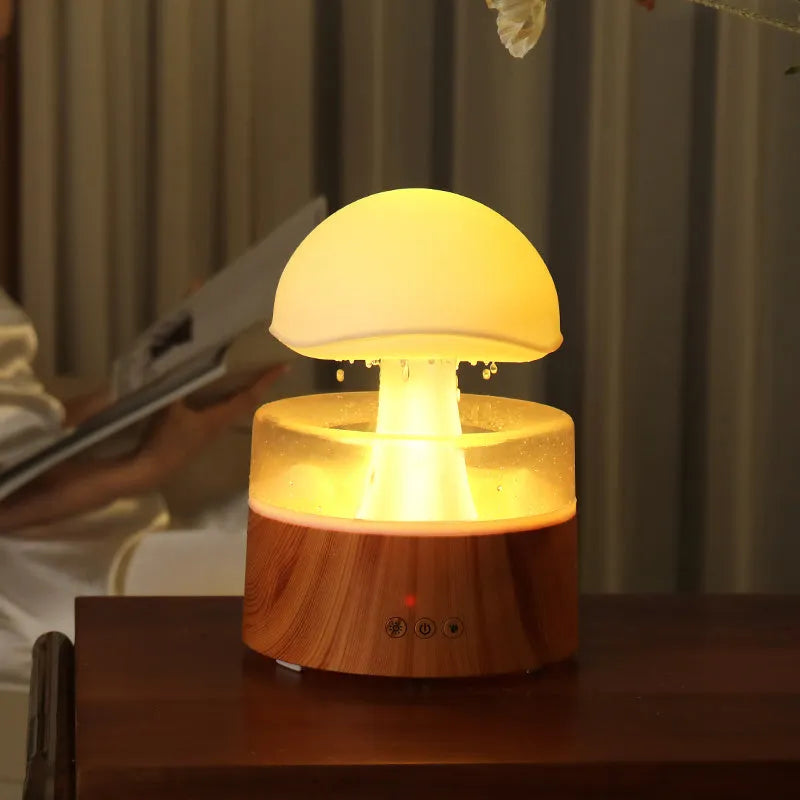 White rain cloud shaped humidifier with falling water droplets and multi-colour lighting