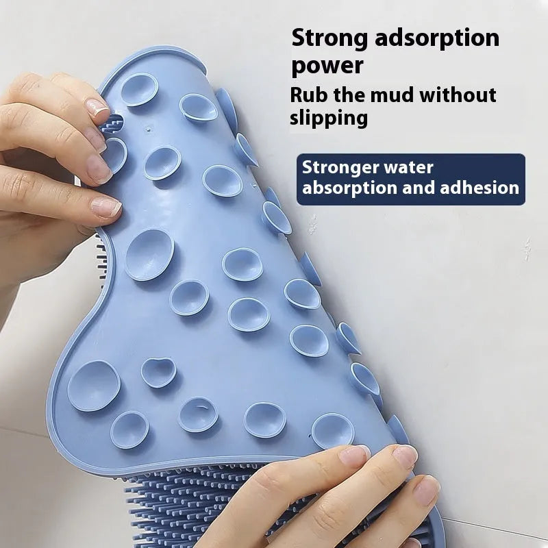 Blue silicone bath massage mat with long handle for back scrubbing.