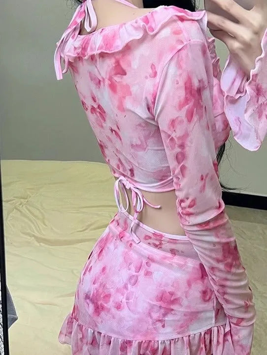 Women's cherry blossom pink floral bikini swimsuit laid flat.