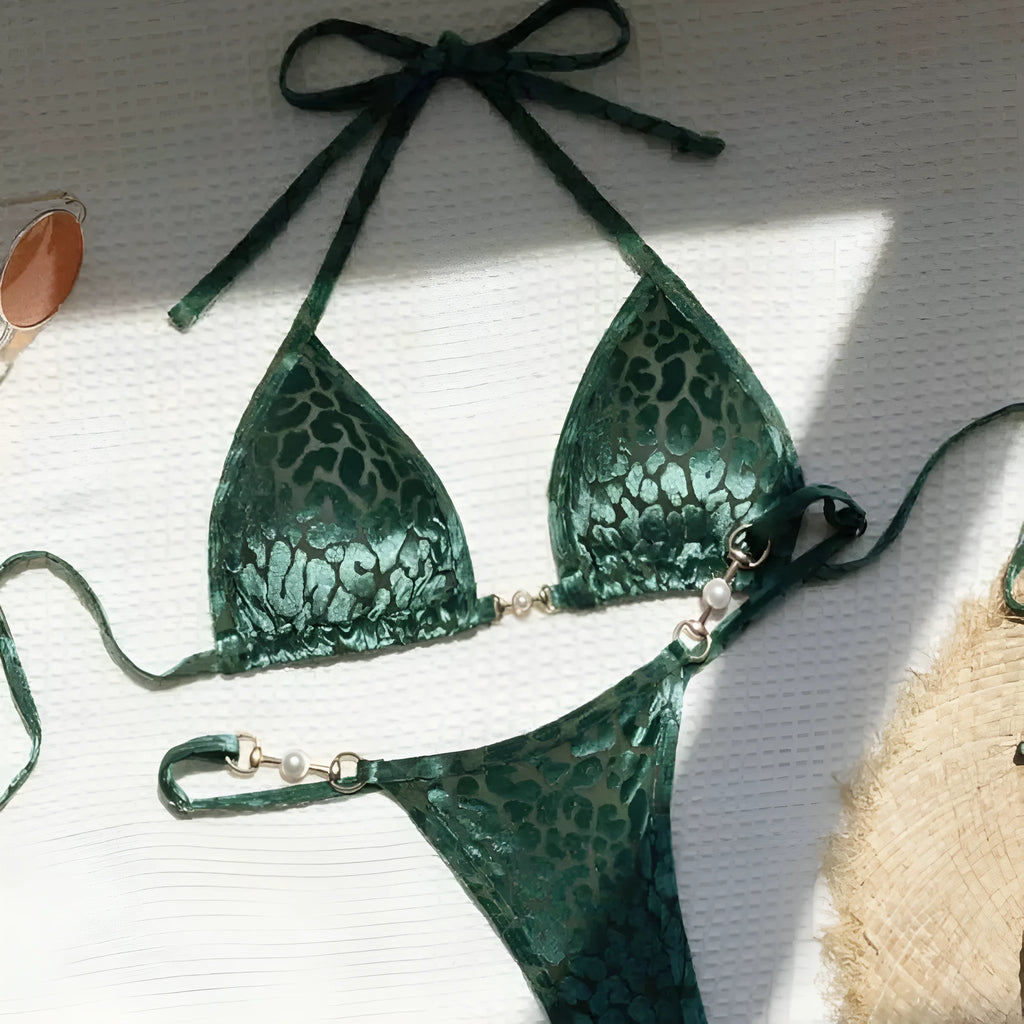 Women's T-shaped leopard print bikini swimsuit in polyester and spandex fabric on a mannequin.