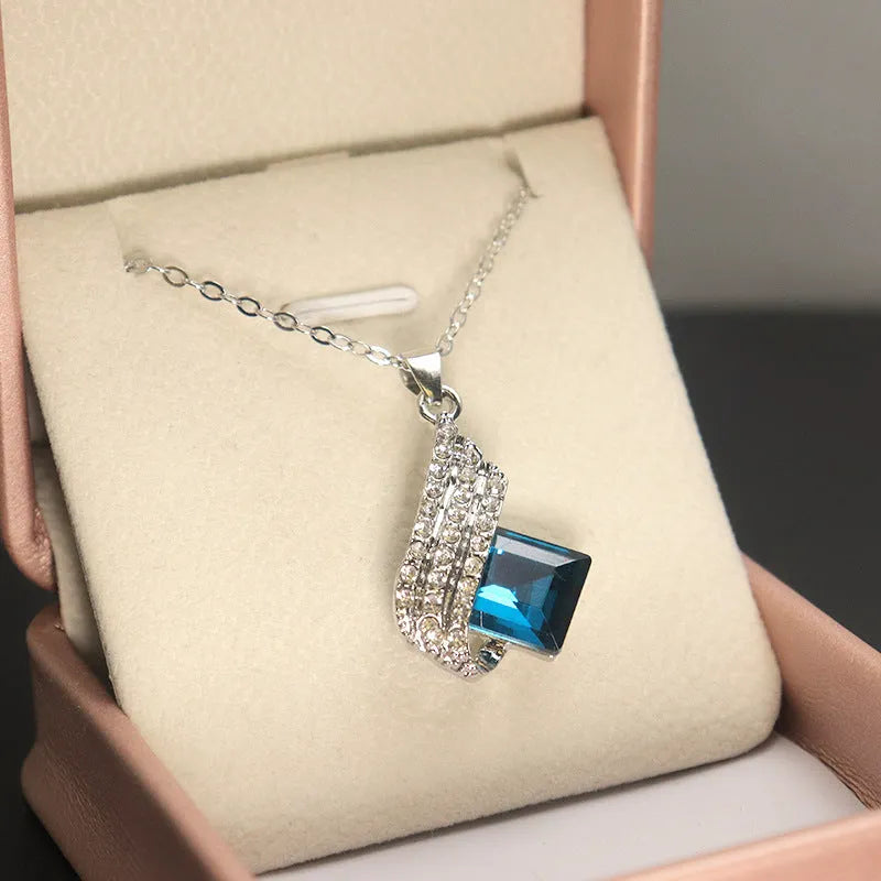Women's necklace and ear stud set with alloy pendant, cross chain, and glass detailing in electroplated finish