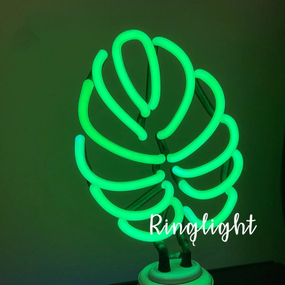 Minimalist bamboo-shaped desktop lamp with white tube emitting green light, USB powered