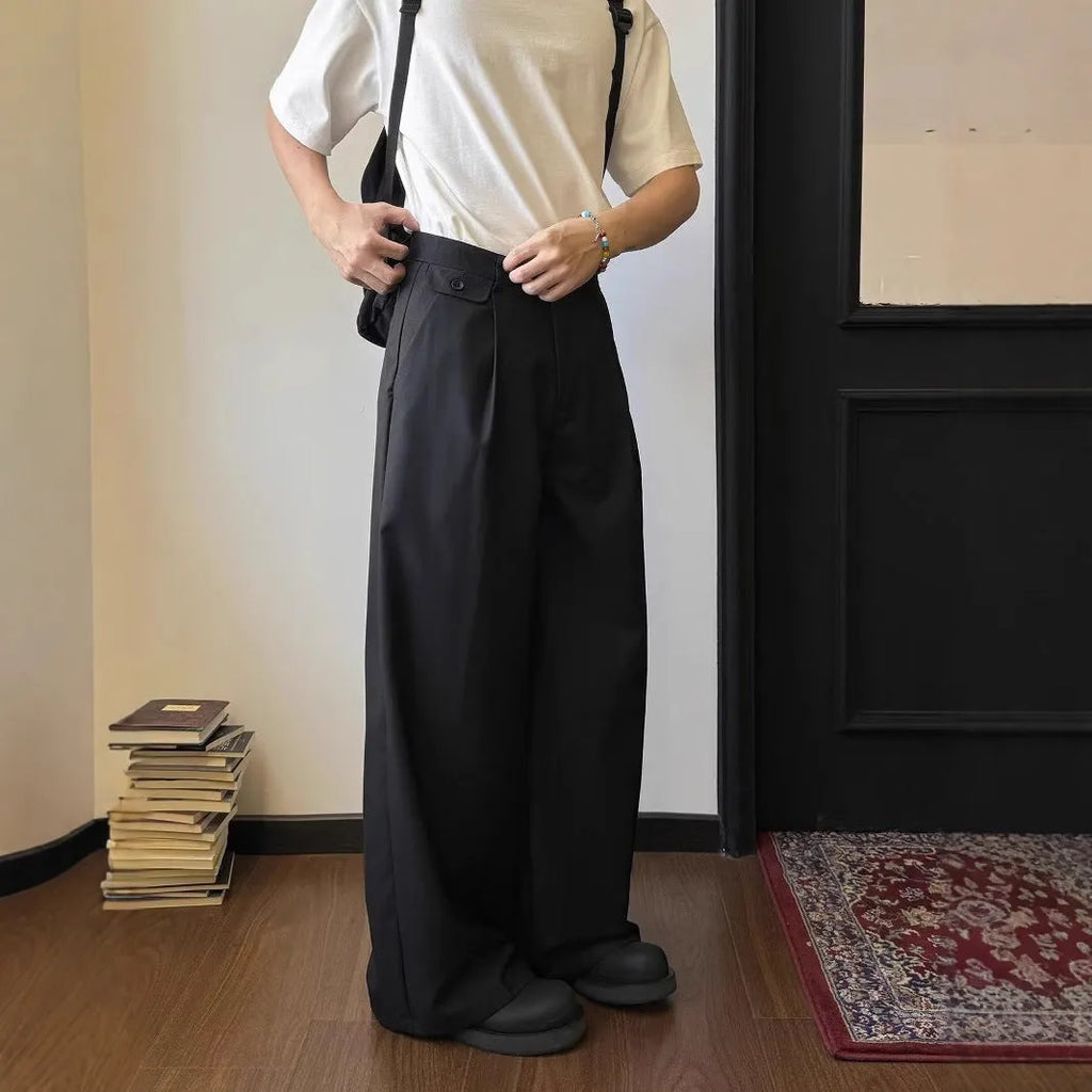 Men's brown straight-leg casual trousers with a loose wide-leg cut on a neutral background.