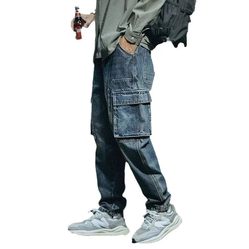 Men's blue loose straight cut retro denim pants with stretch fabric and zip fly, laid flat