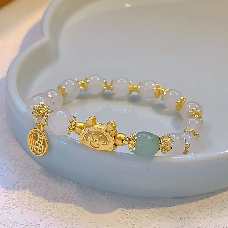 Glass floral glazed bracelet with animal zodiac modelling and electroplated red bead finish